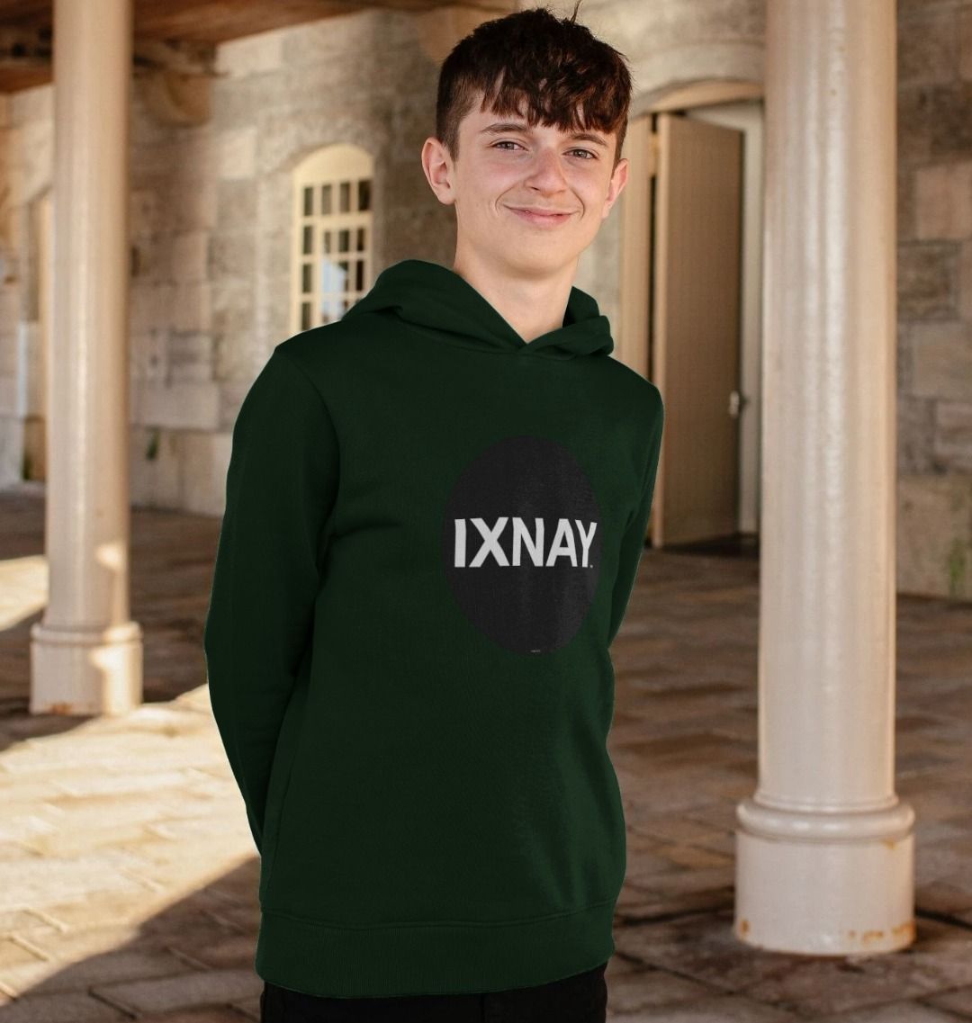 boy standing in front of stone building with columns wearing kids dark green evergreen organic relaxed fit pullover hoodie with original black round IXNAY logo