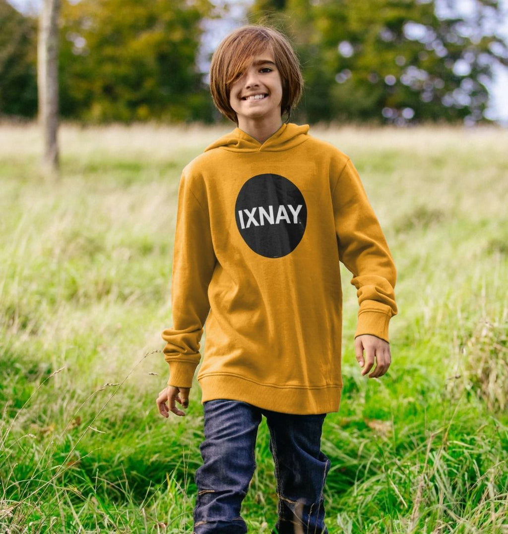 boy in deep grassy field wearing kids mustard yellow organic relaxed fit pullover hoodie with original black round IXNAY logo