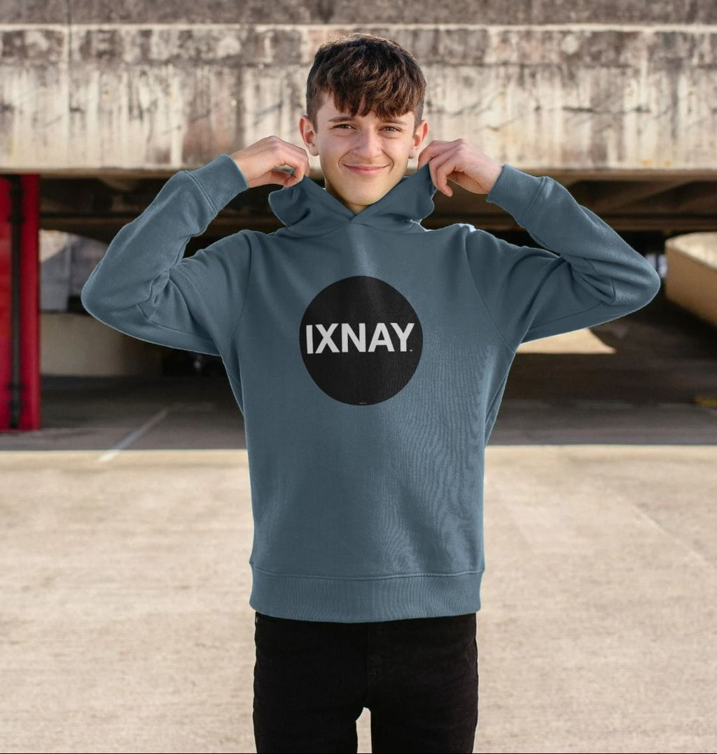 boy in parking garage wearing kids stone blue organic relaxed fit pullover hoodie with original black round IXNAY logo