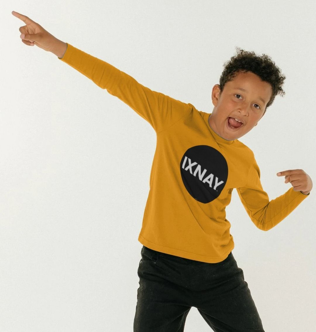 Boy smiling and having fun dancing while wearing a kids mustard yellow organic long-sleeved t-shirt with original black round IXNAY logo
