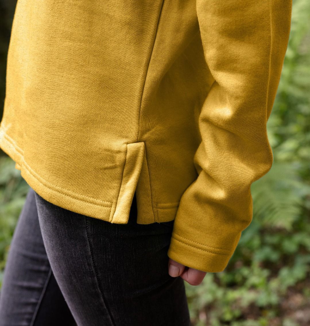 detail image showing side splits of womens sunflower yellow organic remill pullover hoodie with original black round IXNAY logo