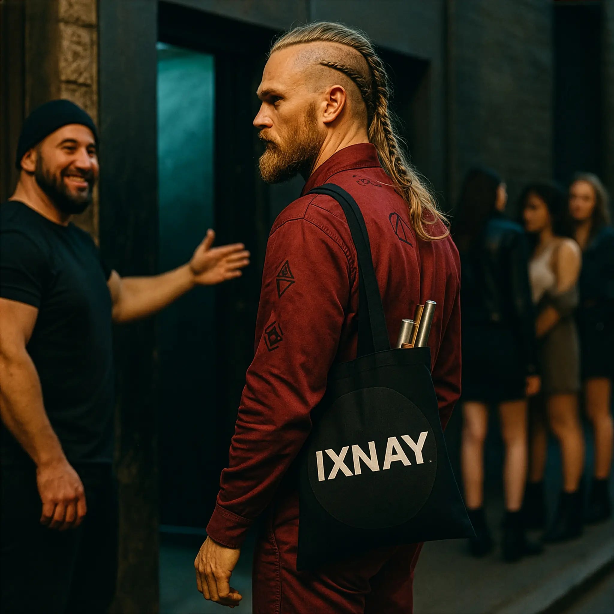 Member of secret society with blonde Viking braids wearing deep red coveralls entering underground night club with an IXNAY original logo tote bag in 100% cotton over his shoulder.