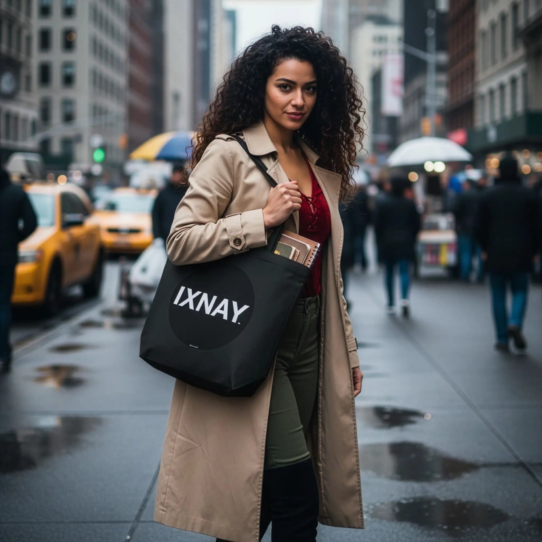 Woman holding an 'IXNAY' bag on a city street wearing an IXNAY Original Logo Canvas Tote Bag - 100% Organic Cotton.