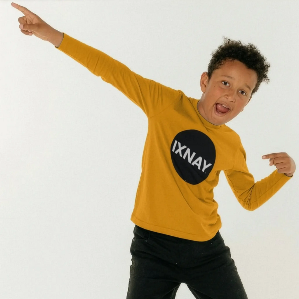 Kid dances wearing IXNAY Kids 100% Organic Cotton Long-Sleeve T-Shirt Original Logo - Mustard Yellow.