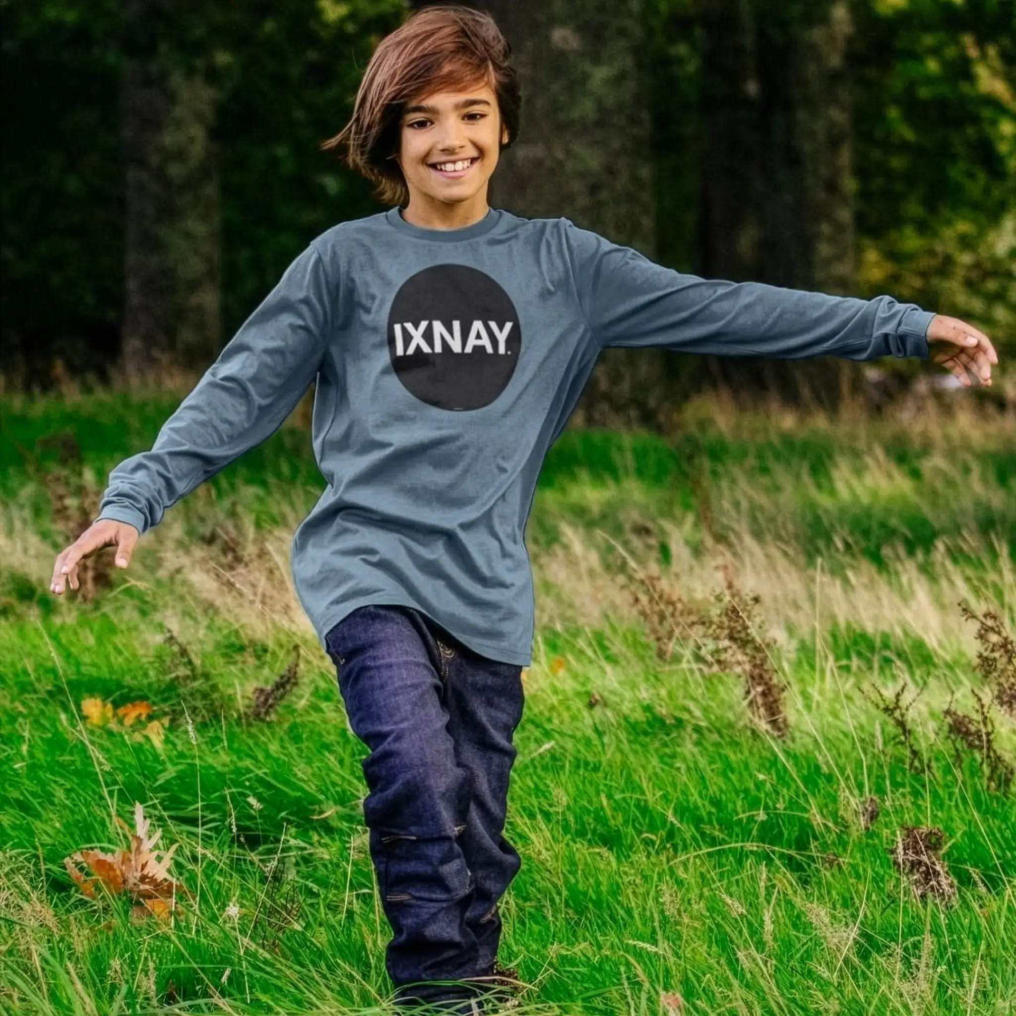 Kid plays wearing IXNAY Kids 100% Organic Cotton Long-Sleeve T-Shirt Original Logo - Stone Blue.