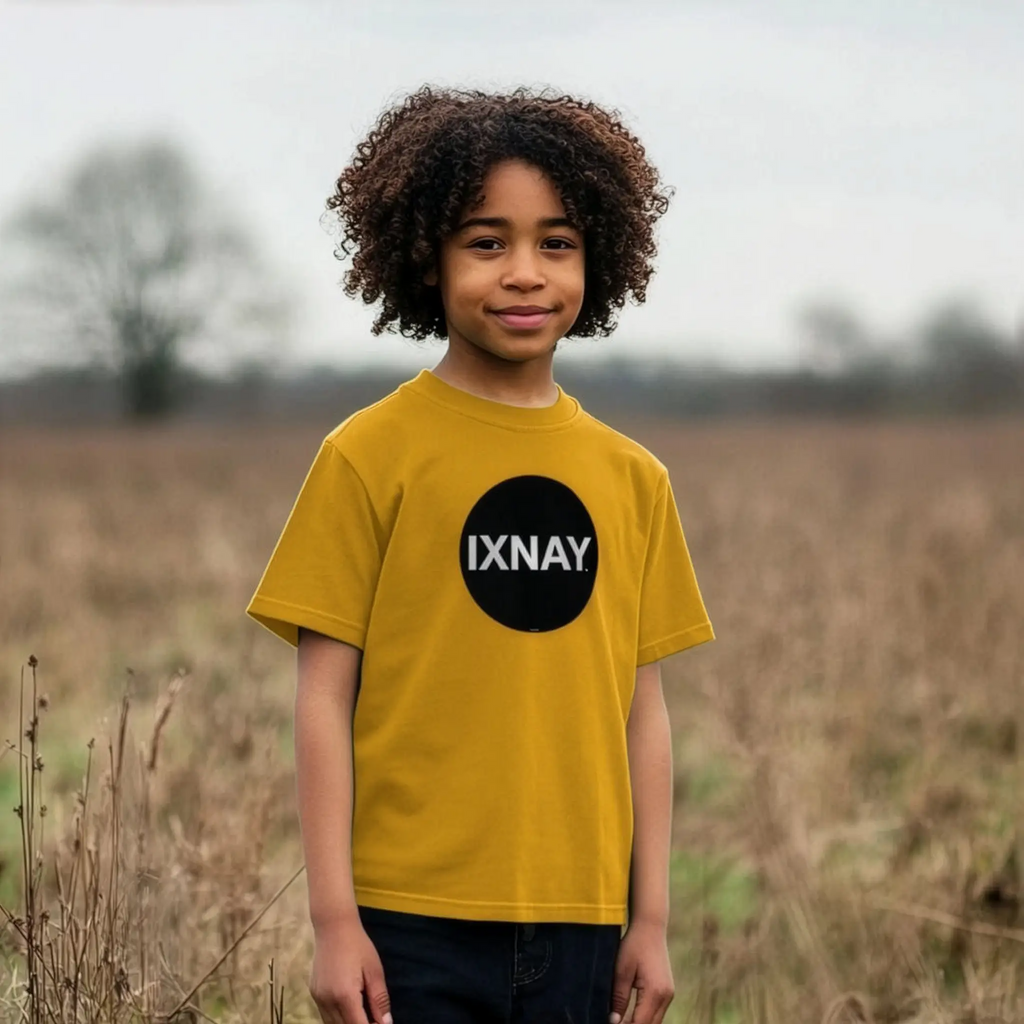 Young boy wearing IXNAY Kids 100% Organic Cotton T-Shirt Original Logo - Mustard Yellow.