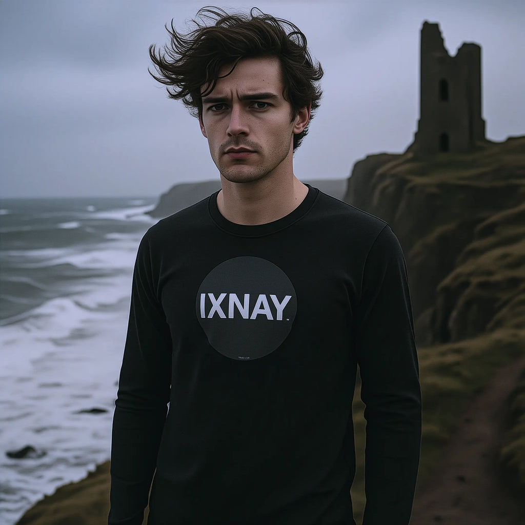 young man on cliff above a storm tossed sea wearing black IXNAY Original Logo 100% cotton long-sleeved t-shirt