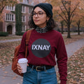 Young woman walking to class on a college campus wearing maroon red IXNAY Original Logo 100% cotton long-sleeved t-shirt.