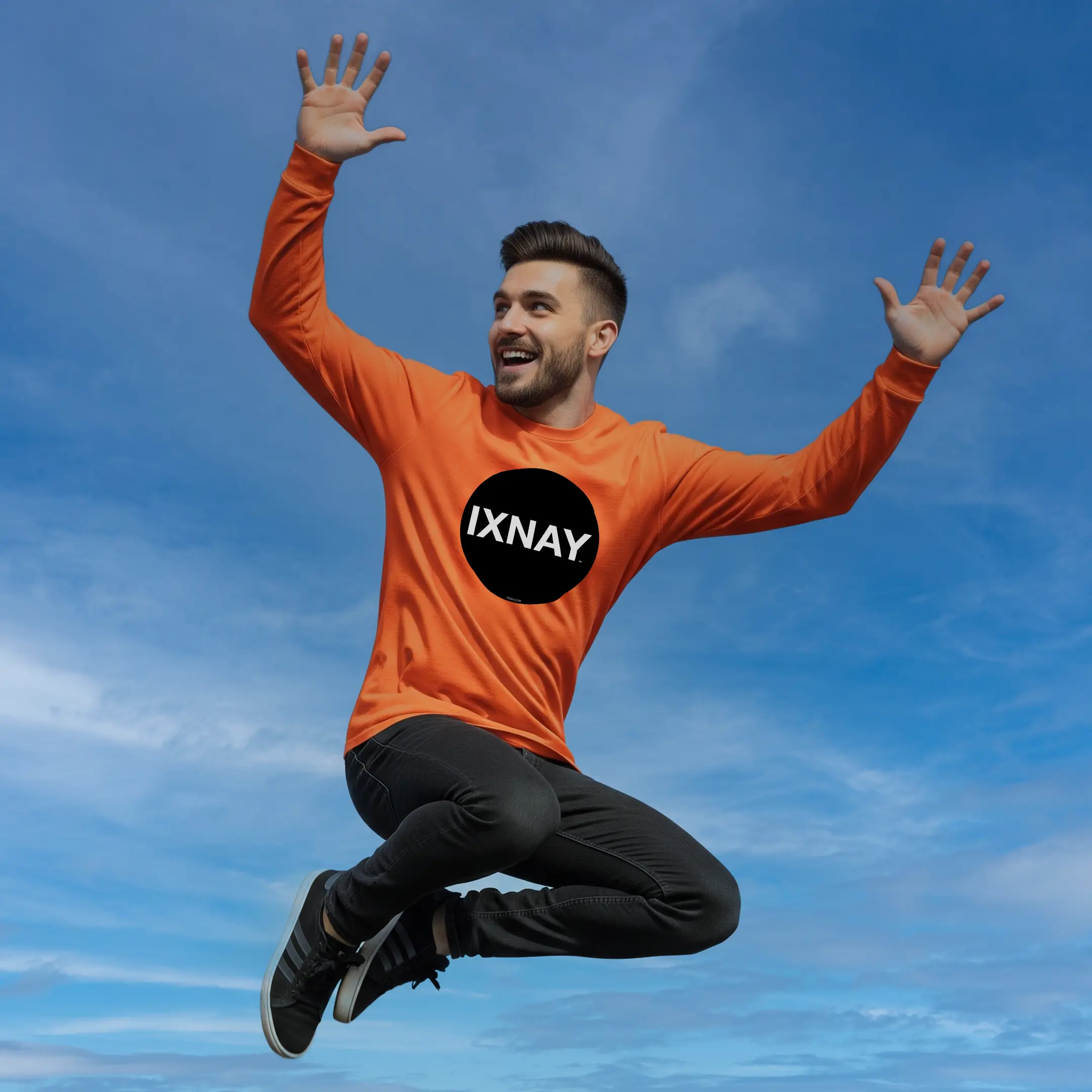 man jumping for joy high into sky wearing orange poppy IXNAY Original Logo 100% cotton long-sleeved t-shirt