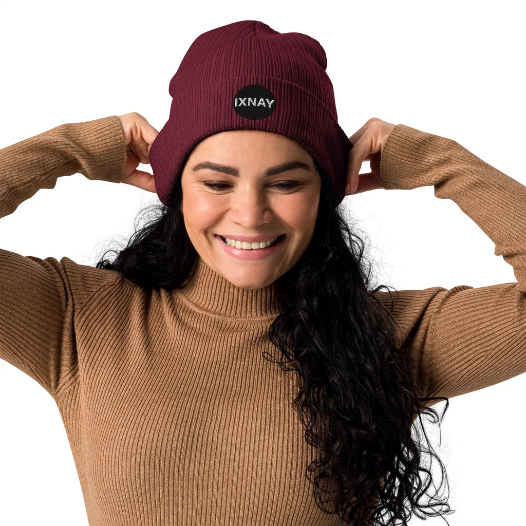Woman having the best time of her life wearing the IXNAY Original Logo 100% organic ribbed beanie in burgundy red