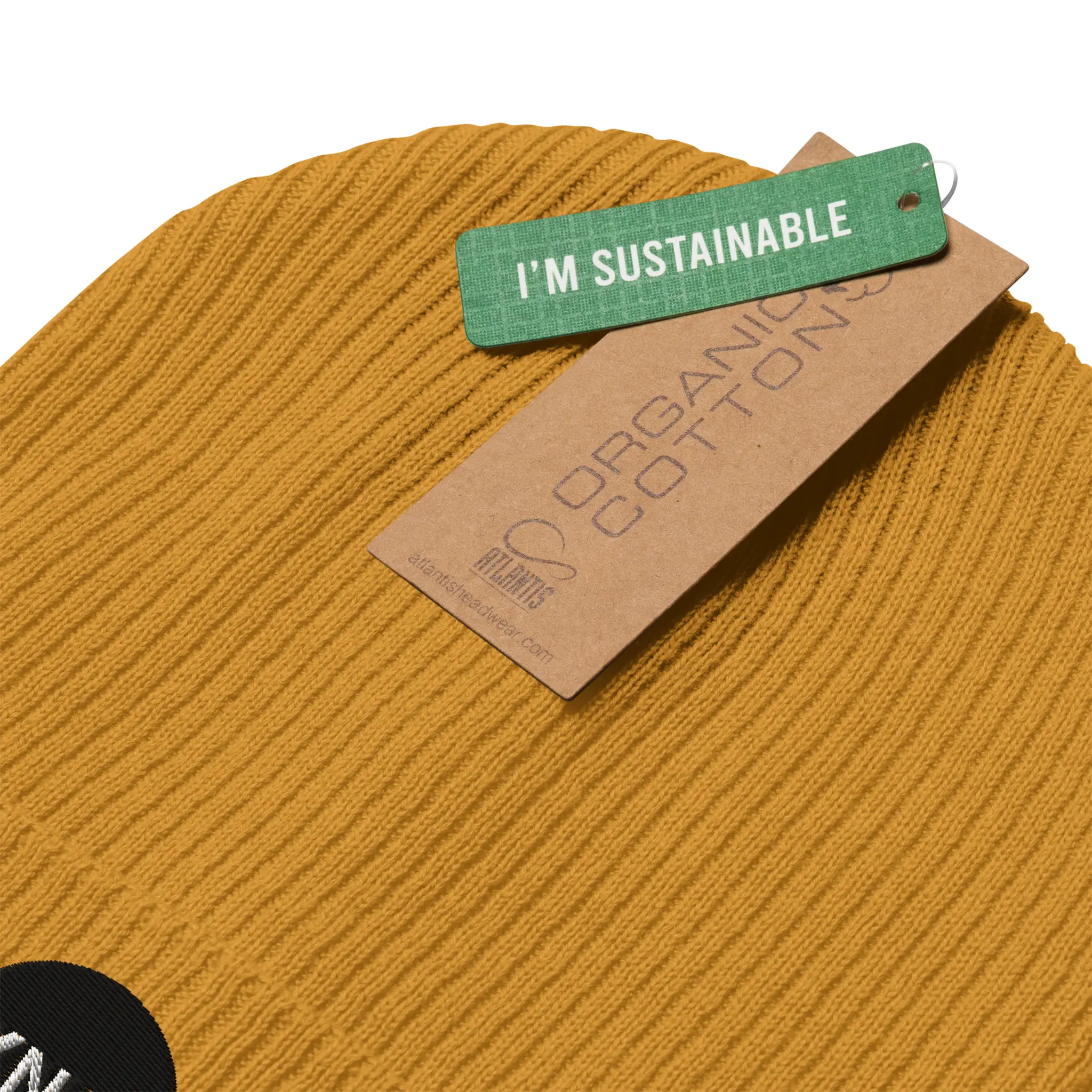 IXNAY Original Logo 100% organic ribbed beanie in mustard yellow detail view of sustainable certification tags