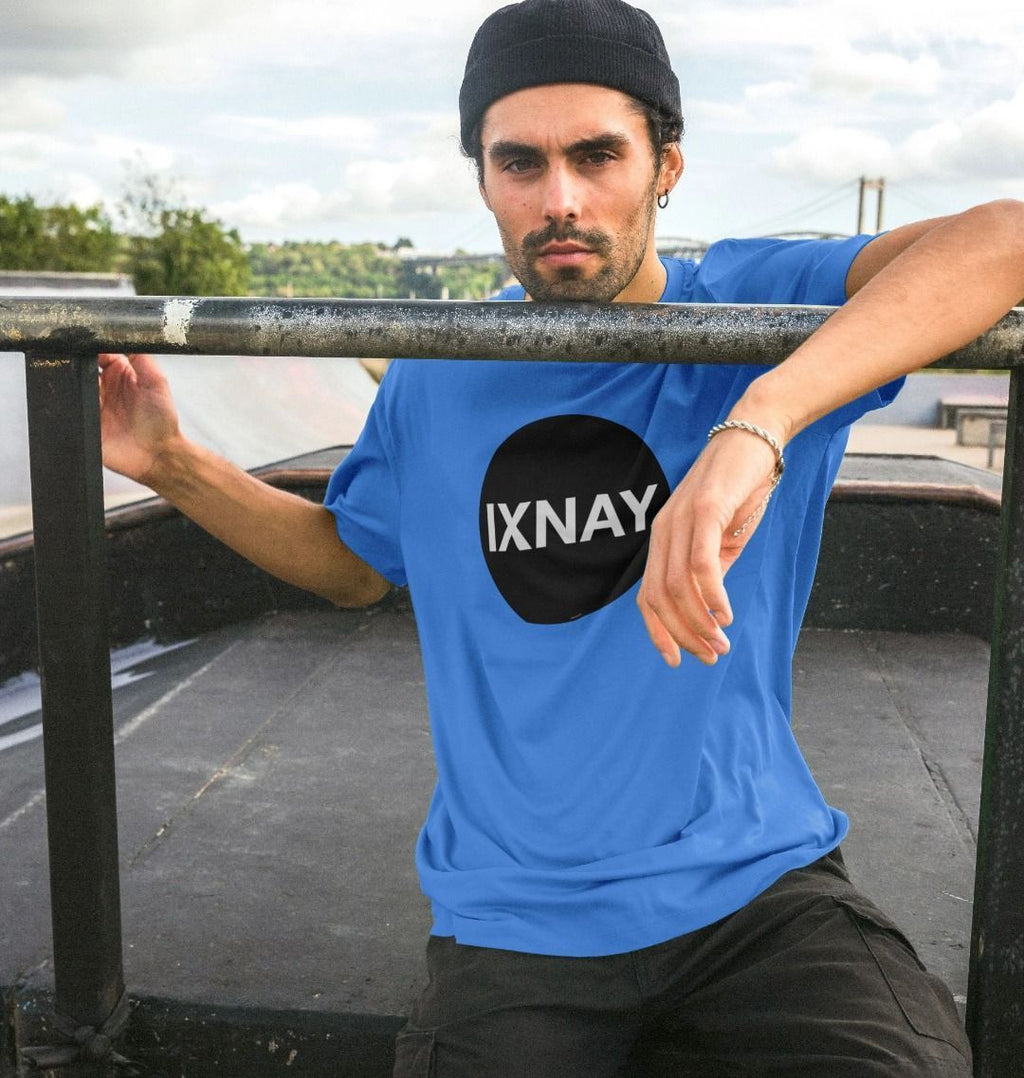 A man models a bright blue t-shirt with a black circular logo that reads 'IXNAY' on the front.