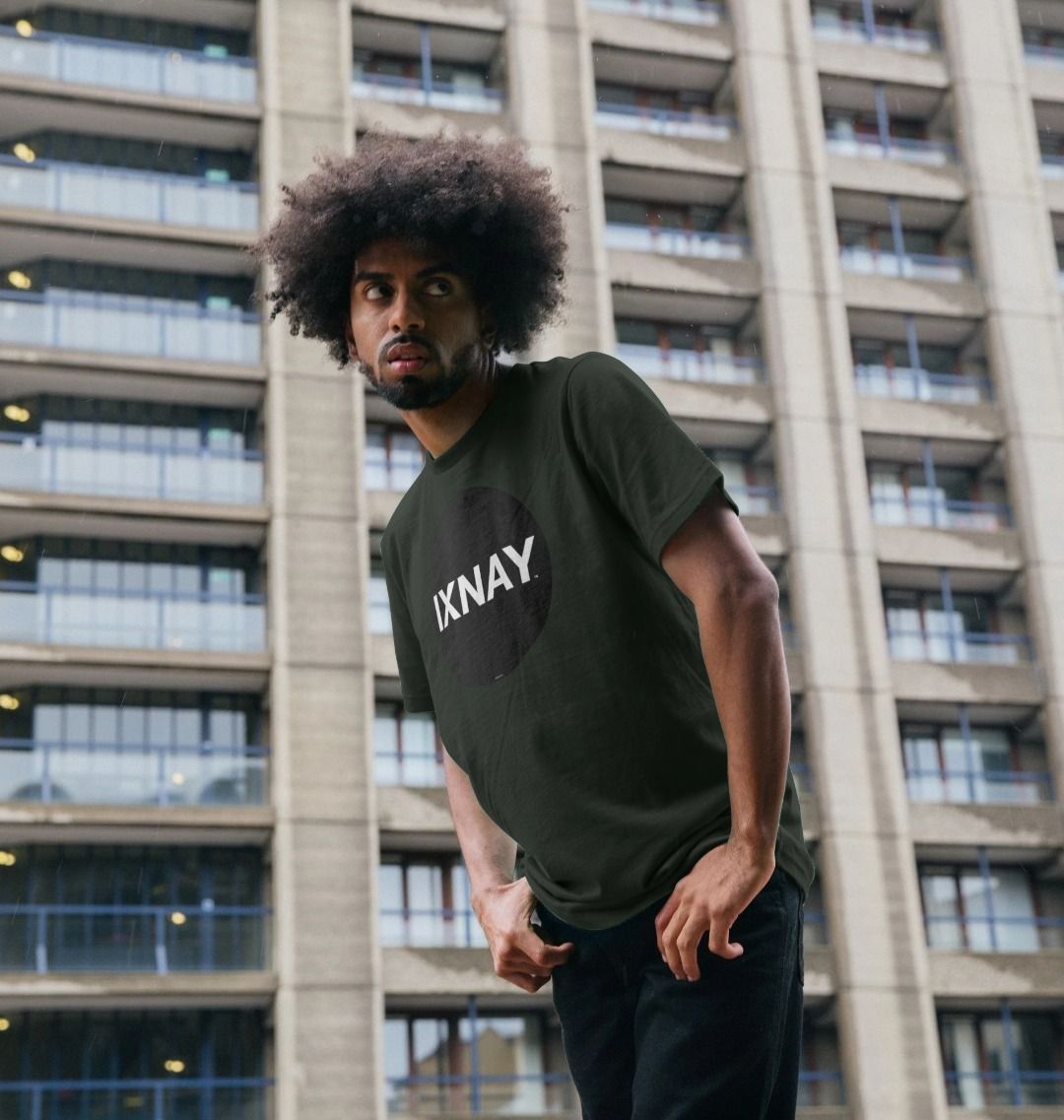 A man models a dark gray t-shirt with a black circular logo that reads 'IXNAY' on the front.