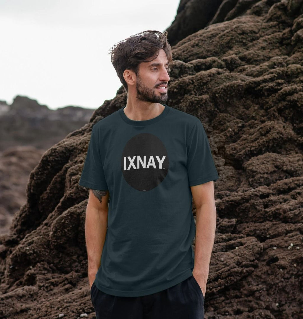 A man models a denim blue t-shirt with a black circular logo that reads 'IXNAY' on the front.