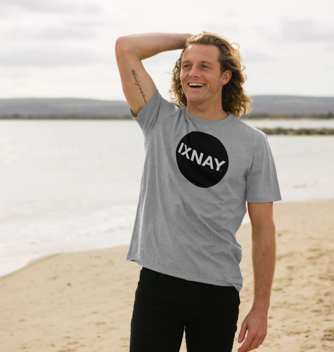 A man models a light gray t-shirt with a black circular logo that reads 'IXNAY' on the front.
