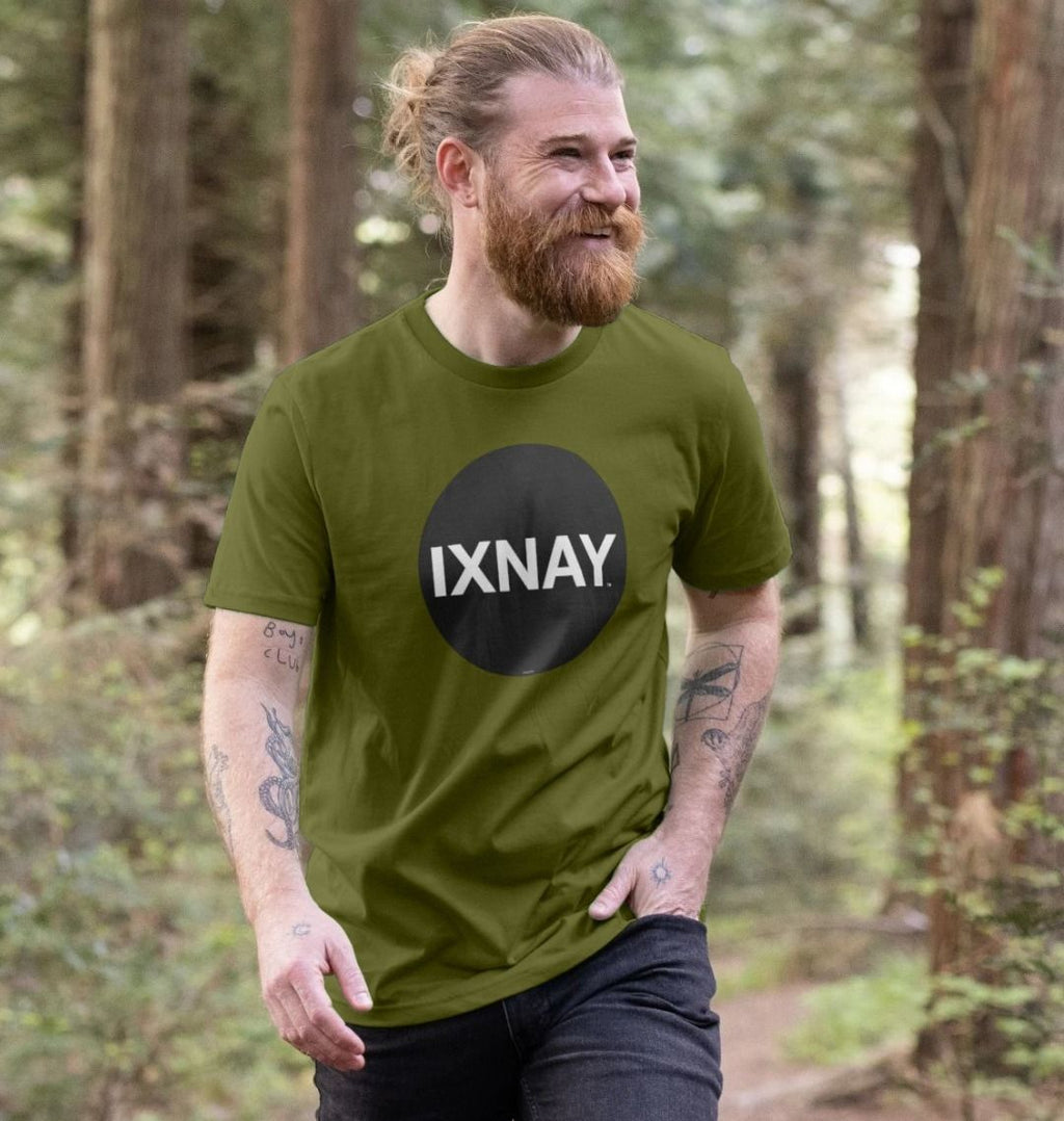 A man models a moss green t-shirt with a black circular logo that reads 'IXNAY' on the front.