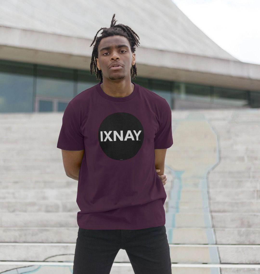 A man models a purple t-shirt with a black circular logo that reads 'IXNAY' on the front.