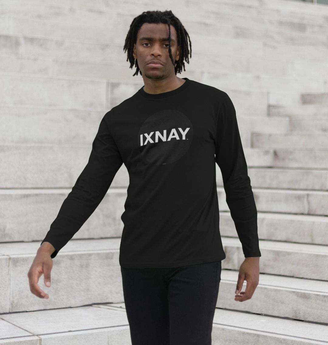 Black man standing on wide marble steps of modern building wearing Black Printed Men's Long-sleeved T-Shirt with Original Black Round IXNAY Logo from the artist and musician IXNAY
