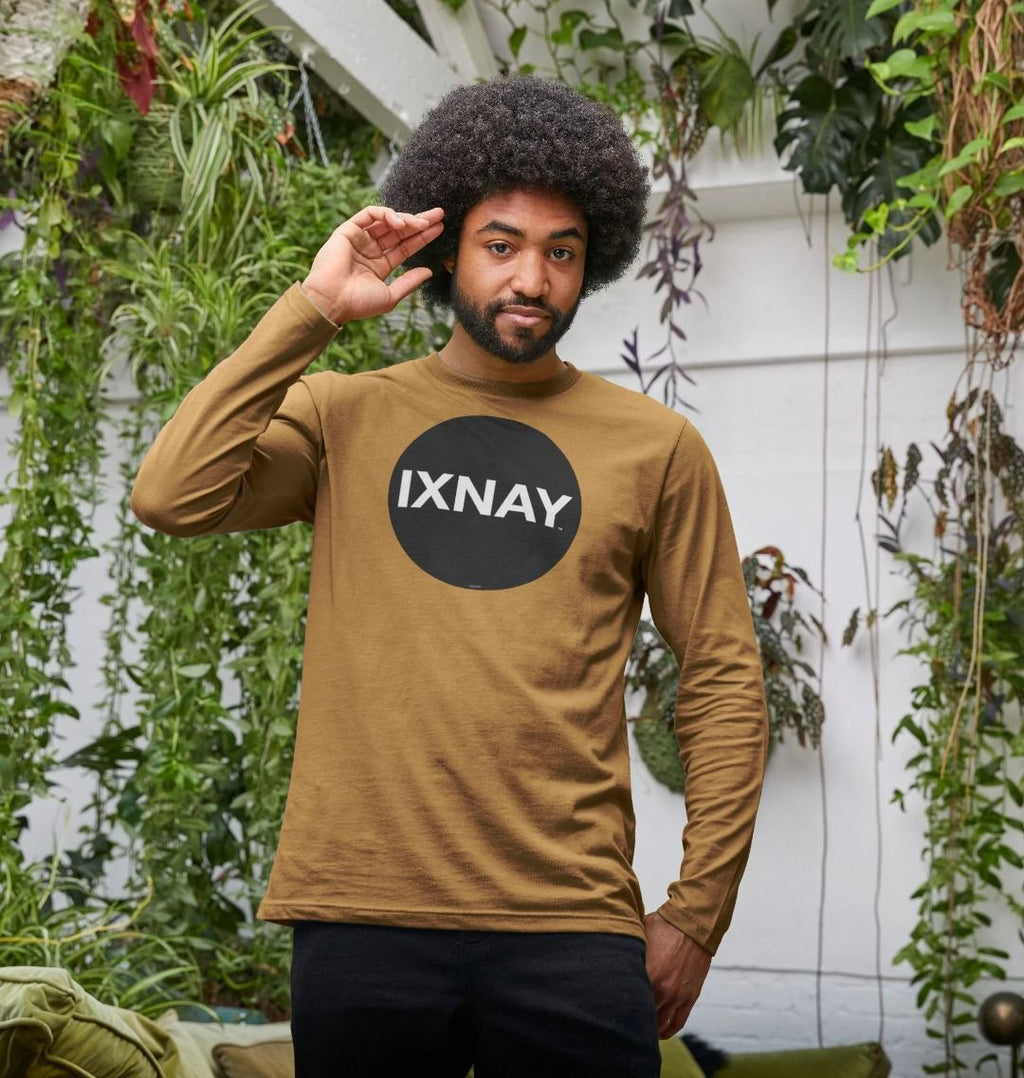 Black man in sun room with plants wearing Brown Printed Men's Long-sleeved T-Shirt with Original Black Round IXNAY Logo from the artist and musician IXNAY
