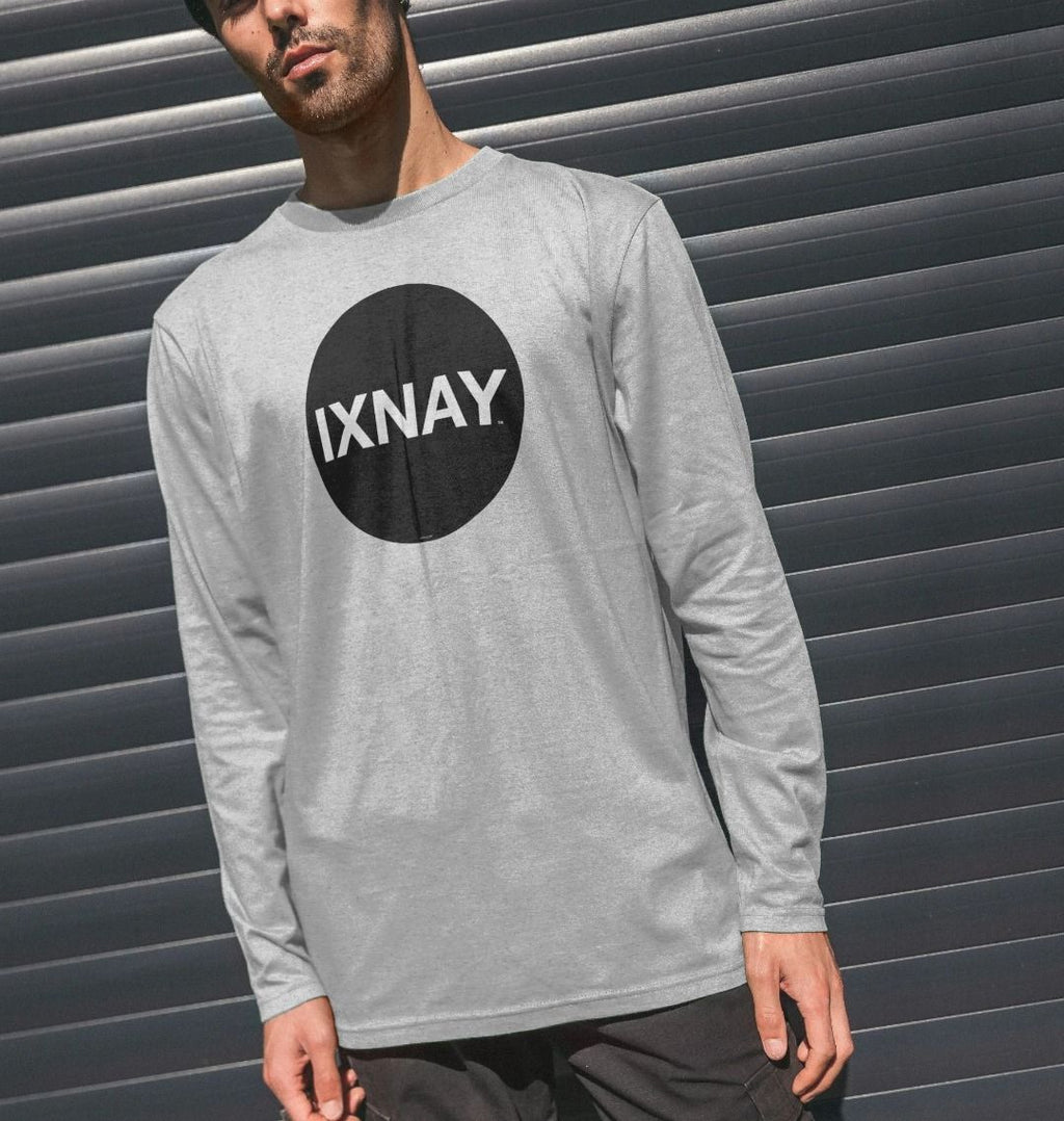 Man in front of metal rollup door wearing Light Gray Printed Men's Long-sleeved T-Shirt with Original Black Round IXNAY Logo from the artist and musician IXNAY