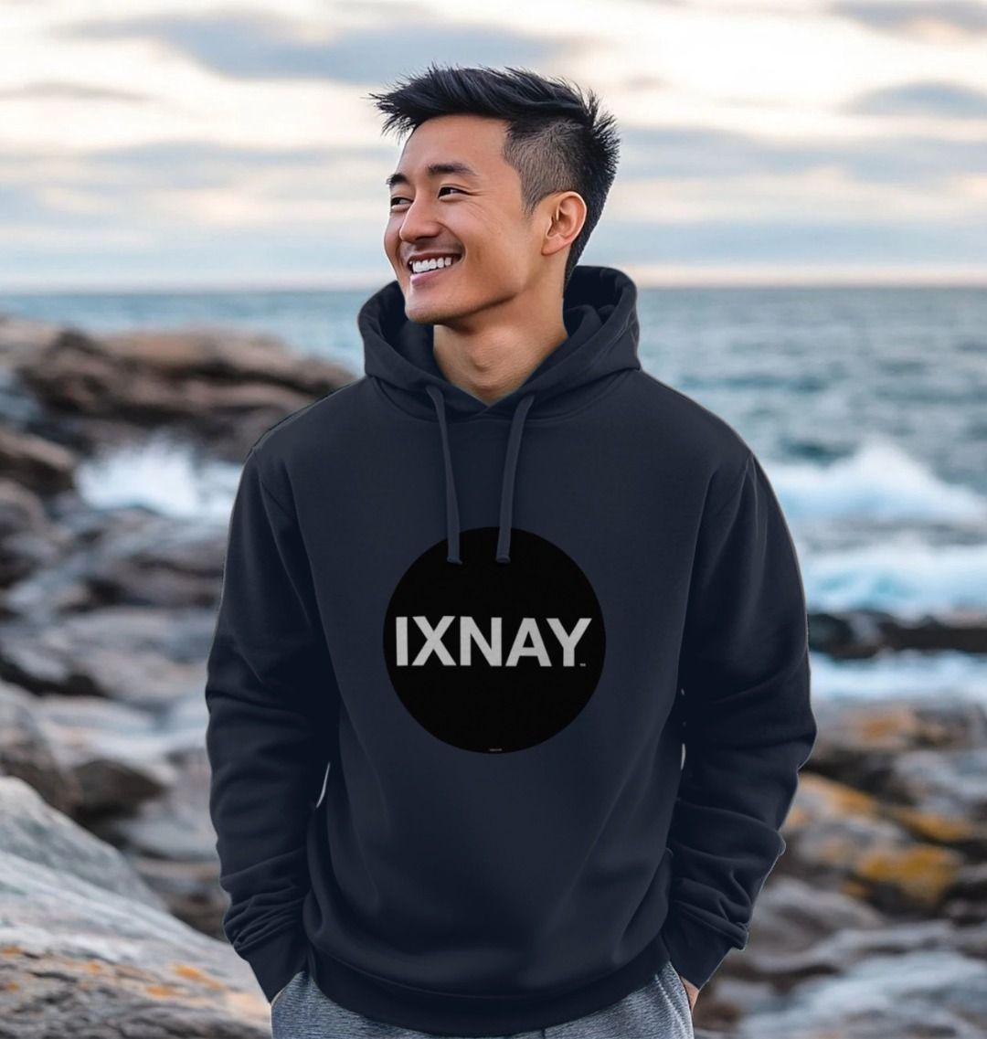 Man walking on rock jetty wearing mens navy blue organic cotton pullover hoodie with original black round IXNAY logo