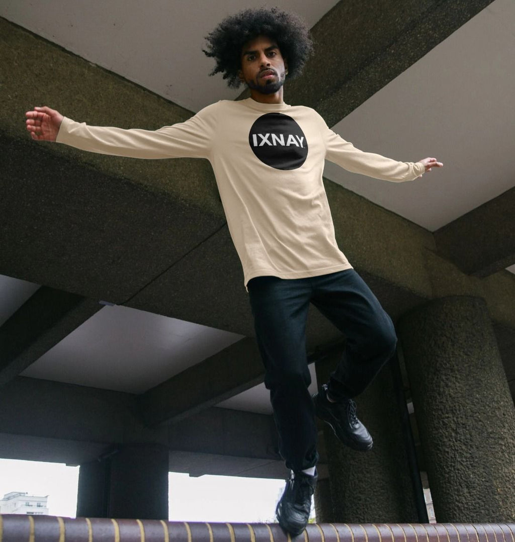 Black man jumping for joy in parking garage wearing Oat off-white Printed Men's Long-sleeved T-Shirt with Original Black Round IXNAY Logo from the artist and musician IXNAY