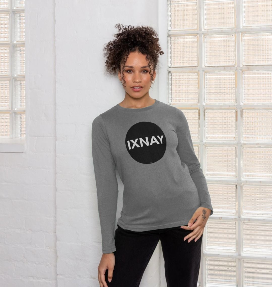 Woman in front of glass brick wall wearing  light gray Printed Women's Long-sleeved T-Shirt with Original Black Round IXNAY Logo from the artist and musician IXNAY