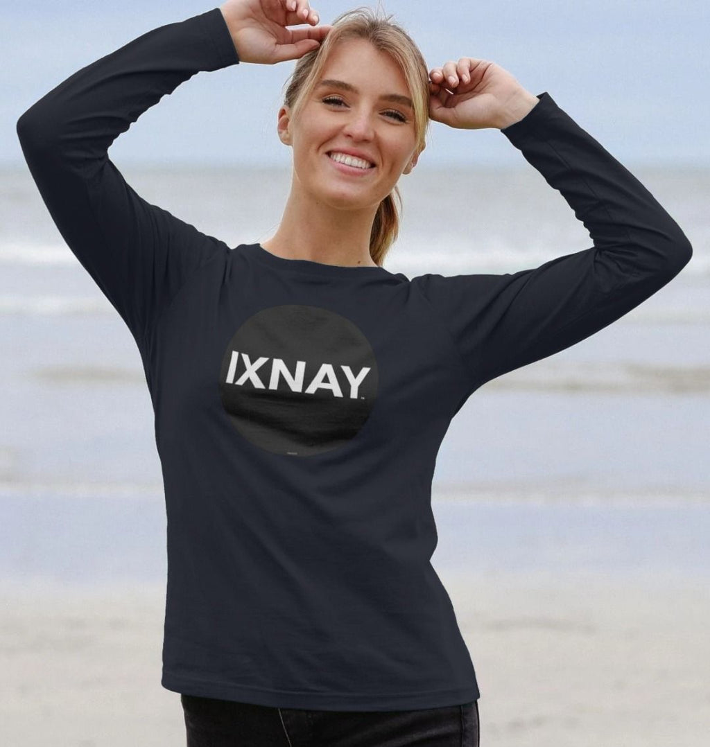 Woman on sandy beach wearing navy blue Printed Women's Long-sleeved T-Shirt with Original Black Round IXNAY Logo from the artist and musician IXNAY