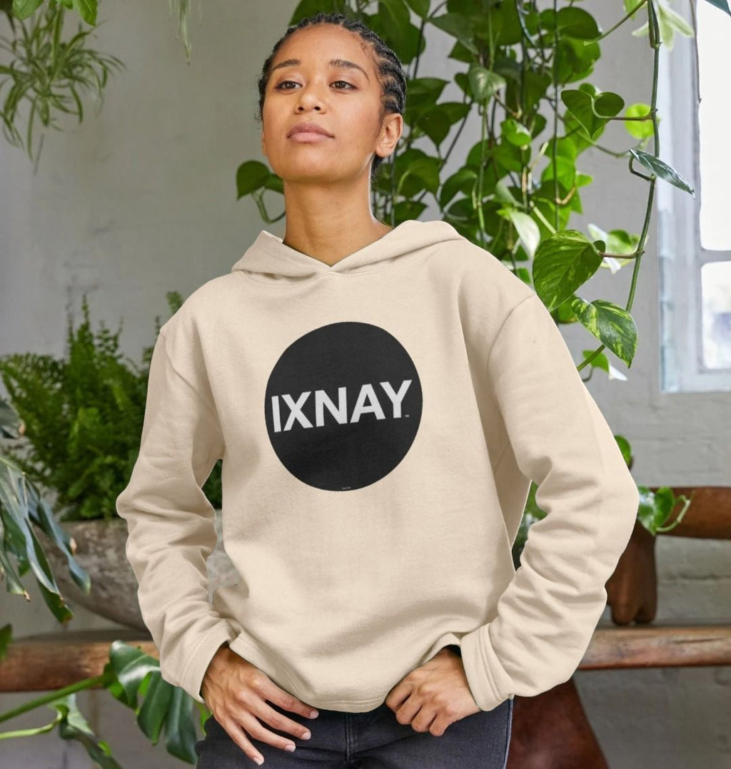 Woman with cornrows wearing women's oat colored light beige organic pullover hoodie with original black round IXNAY logo