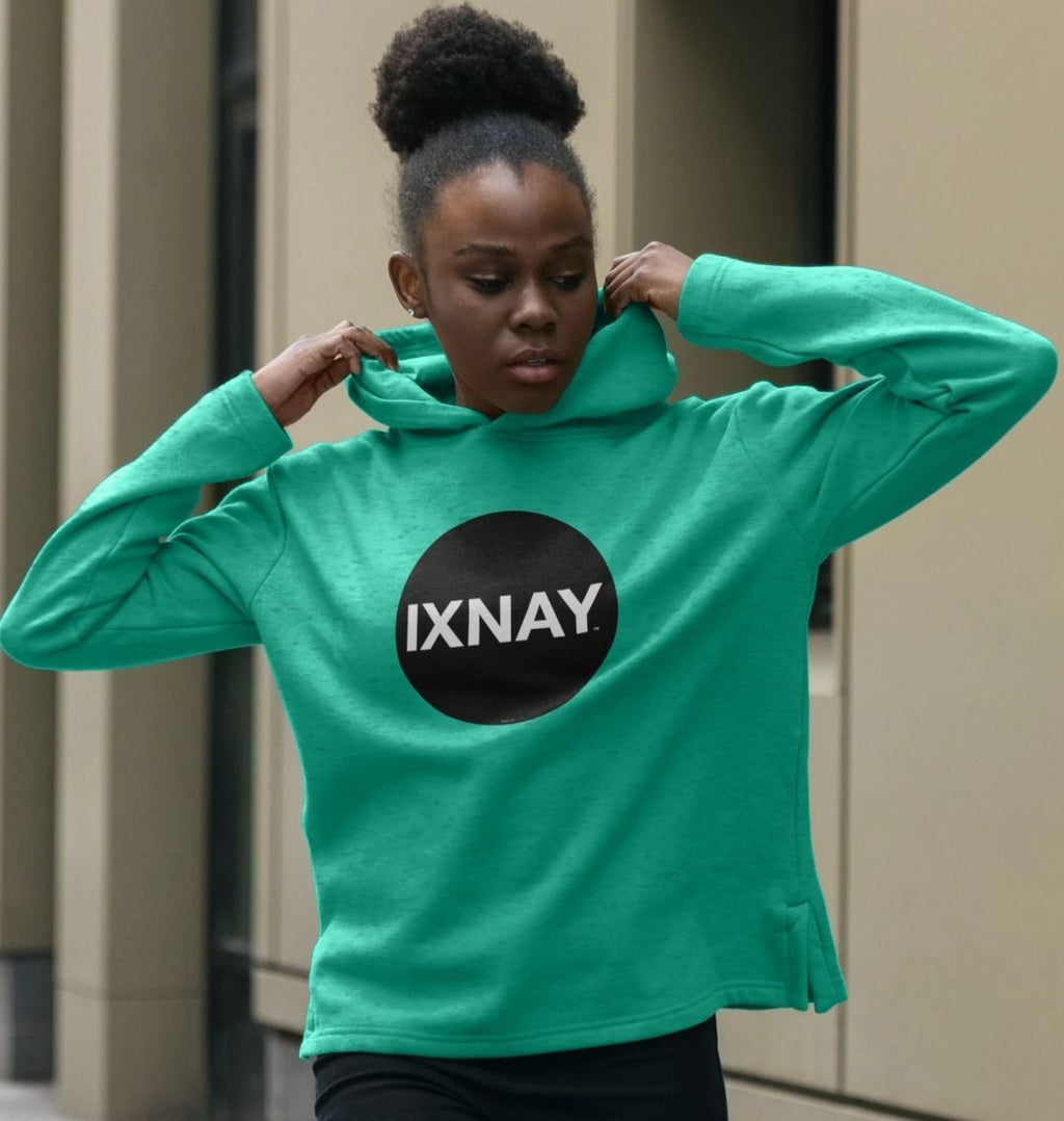 woman wearing womens seagrass green organic remill pullover hoodie with original black round IXNAY logo